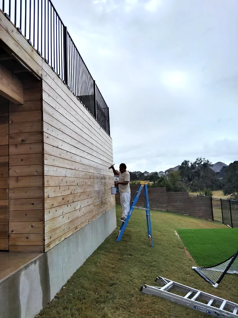 Bee Cave exterior storage unit staining work beside the deck