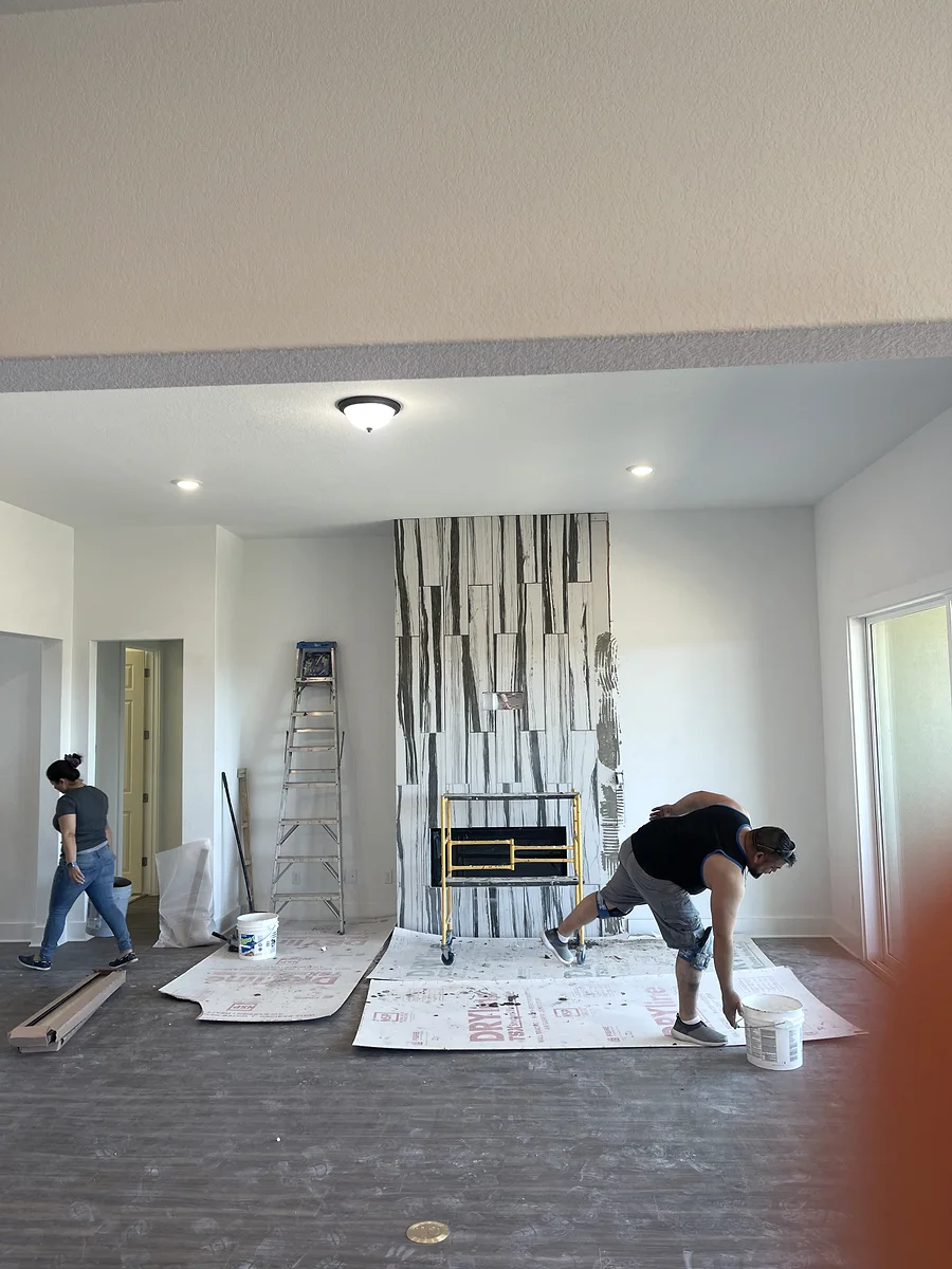 Bee Cave wall tile feature in progress around the living room fireplace and TV wall